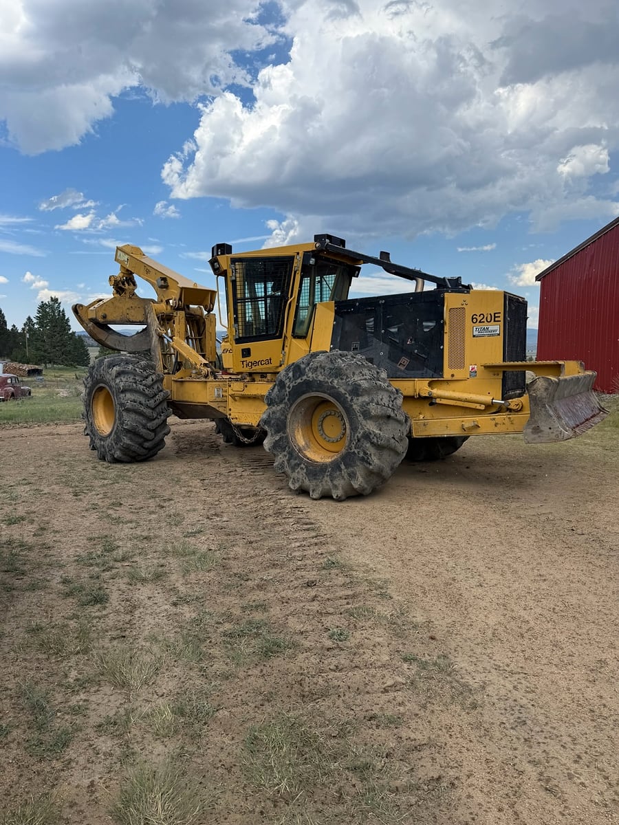 Over The Top's Tigercat 620E grapple skidder under a big Montana sky
